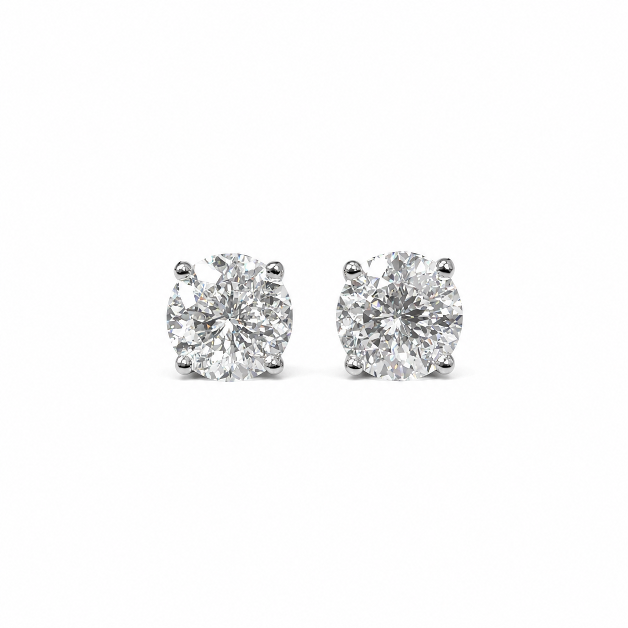 Pair of classic moissanite stud earrings on white background