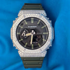 Casio G-Shock watch with diamond-studded bezel on a blue background